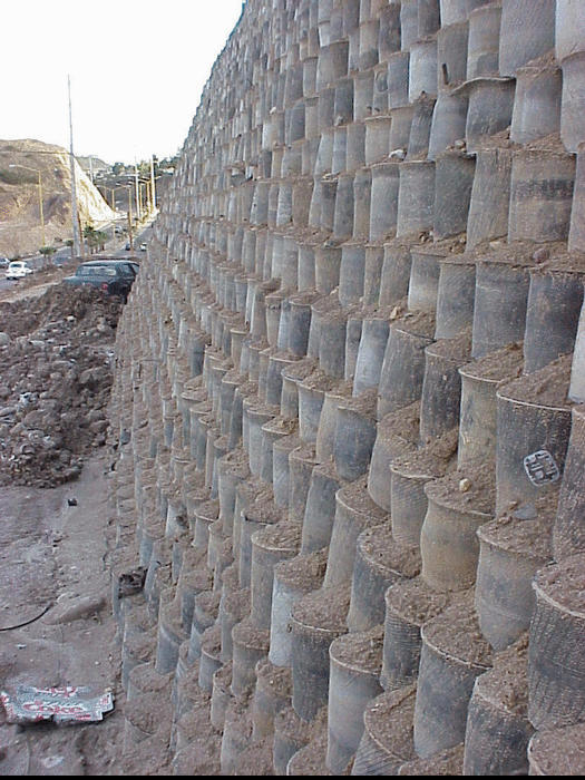 Side view of retaining wall built with discarded tires.