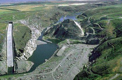 Teton dam as it is today. The left side is where the breach occurred.  The damage to the face and right side
was done by engineers and other inspection teams trying to determine the cause of the failure